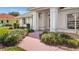Inviting front entrance showcasing well-manicured landscaping and a charming walkway at 217 Rockwood Way, Englewood, FL 34223