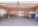 Spacious two car garage painted pink and ample storage space with white cabinets and shelving throughout at 217 Rockwood Way, Englewood, FL 34223