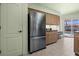Kitchen with stainless steel refrigerator and convenient access to the pool area at 217 Rockwood Way, Englewood, FL 34223