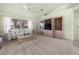 Bright living room featuring a comfortable sofa, built-in shelving, and large windows for natural light at 217 Rockwood Way, Englewood, FL 34223