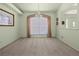 Light-filled living room with neutral carpet, large window and decorative lighting at 217 Rockwood Way, Englewood, FL 34223