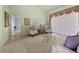Cozy living area with plush armchairs, a glass coffee table, and a large window at 217 Rockwood Way, Englewood, FL 34223