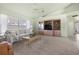 Cozy living room with a large window, entertainment center, and comfortable seating at 217 Rockwood Way, Englewood, FL 34223