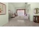 Bright living room with neutral paint, plush carpet, and sheer curtains for soft, natural light at 217 Rockwood Way, Englewood, FL 34223