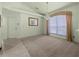 Spacious living room with plush carpeting, large window, and elegant chandelier at 217 Rockwood Way, Englewood, FL 34223