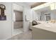 Elegant main bathroom with a soaking tub and vanity with an oversized mirror at 217 Rockwood Way, Englewood, FL 34223