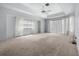 Spacious main bedroom featuring a trey ceiling, fan, and ample natural light at 217 Rockwood Way, Englewood, FL 34223
