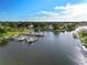 Scenic waterfront featuring boats docked along a canal, surrounded by lush greenery and neighborhood views at 217 Rockwood Way, Englewood, FL 34223