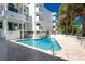 Inviting pool area with clear blue water and palm trees, offering a refreshing and relaxing outdoor experience at 2380 N Beach Rd # 108, Englewood, FL 34223