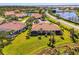 Beautiful aerial shot of a well-maintained home with a manicured lawn in a lakeside community at 2625 Wax Myrtle, Port Charlotte, FL 33953