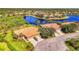 Aerial view of houses featuring tile roofs, landscaped yards, and lake views within a quiet community at 2625 Wax Myrtle, Port Charlotte, FL 33953