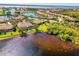 Beautiful aerial showcasing a lakeside home with lush greenery and scenic water views at 2625 Wax Myrtle, Port Charlotte, FL 33953