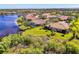 Beautiful waterfront homes with tile roofs, lush landscaping, and serene lake views create a picturesque setting at 2625 Wax Myrtle, Port Charlotte, FL 33953
