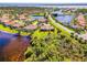 Aerial view of a home in a lakeside community, offering stunning views and a serene environment at 2625 Wax Myrtle, Port Charlotte, FL 33953