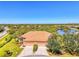 Beautiful lakefront property with lush landscaping, barrel tile roof, and a two-car garage at 2625 Wax Myrtle, Port Charlotte, FL 33953