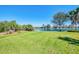 Serene backyard with lush green lawn and a tranquil pond view, perfect for relaxation and outdoor enjoyment at 2625 Wax Myrtle, Port Charlotte, FL 33953