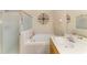 Well-lit bathroom with tub, shower, and tiled floors, with glass shower area at 2625 Wax Myrtle, Port Charlotte, FL 33953