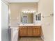 Bright bathroom featuring double vanity, tub, and tiled floors, with glass shower area at 2625 Wax Myrtle, Port Charlotte, FL 33953