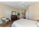 Comfortable bedroom with wood floors, ceiling fan, dresser, and decor at 2625 Wax Myrtle, Port Charlotte, FL 33953