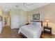 Comfortable bedroom with wood floors, two bedside tables, and a view into the hall and bathroom at 2625 Wax Myrtle, Port Charlotte, FL 33953
