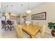 Open-concept dining room with wood table, chairs, and views into the adjacent kitchen and breakfast bar at 2625 Wax Myrtle, Port Charlotte, FL 33953