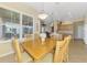Dining area showcasing natural light from large windows, wooden table, and an open-concept layout at 2625 Wax Myrtle, Port Charlotte, FL 33953