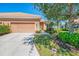 Inviting front exterior with manicured lawn, mature trees, and attached two-car garage in a residential neighborhood at 2625 Wax Myrtle, Port Charlotte, FL 33953