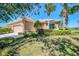 Charming single-story home with well-maintained lawn, mature palm trees, and attached two-car garage at 2625 Wax Myrtle, Port Charlotte, FL 33953