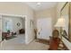 Inviting foyer with tile flooring, a console table, and an open doorway leading to a comfortable living space at 2625 Wax Myrtle, Port Charlotte, FL 33953