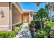 Charming front entrance with manicured bushes and flowering plants leading to the front door of the home at 2625 Wax Myrtle, Port Charlotte, FL 33953