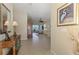 Inviting hallway with tile flooring leading to the home's living spaces and offering views of the outdoors at 2625 Wax Myrtle, Port Charlotte, FL 33953