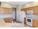 Well-lit kitchen featuring white appliances and light wood cabinets at 2625 Wax Myrtle, Port Charlotte, FL 33953