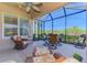 Covered lanai featuring wicker furniture, a ceiling fan, and view of lush greenery at 2625 Wax Myrtle, Port Charlotte, FL 33953