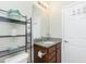Bathroom featuring a vanity with a granite countertop, shelving, and a white door at 2628 Sherman Oak Dr, North Port, FL 34289
