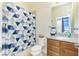 Bathroom featuring a vanity with a granite countertop and a shower with a blue geometric curtain at 2628 Sherman Oak Dr, North Port, FL 34289