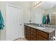 Bright bathroom with a double vanity, granite countertop, and enclosed shower at 2628 Sherman Oak Dr, North Port, FL 34289