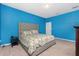 Comfortable bedroom featuring a plush bed with a floral pattern and light-filled space at 2628 Sherman Oak Dr, North Port, FL 34289
