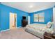Bright bedroom with a floral patterned bedspread, accent dresser and ensuite bathroom access at 2628 Sherman Oak Dr, North Port, FL 34289