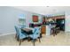 Dining area features a modern table with bench seating and kitchen access at 2628 Sherman Oak Dr, North Port, FL 34289