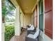 Inviting porch with wicker seating and a view of the lush landscaping at 2628 Sherman Oak Dr, North Port, FL 34289