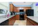 The kitchen with stainless steel appliances, granite countertops, and light blue walls at 2628 Sherman Oak Dr, North Port, FL 34289