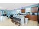 Open kitchen featuring an island with seating and stainless steel appliances at 2628 Sherman Oak Dr, North Port, FL 34289