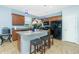 A kitchen with an island, barstools, granite countertops, and stainless steel appliances at 2628 Sherman Oak Dr, North Port, FL 34289