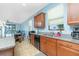 The open kitchen offers wood cabinets and a view into the bright, airy living area at 2628 Sherman Oak Dr, North Port, FL 34289