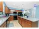 Features a kitchen with granite countertops, an island, and brown cabinets at 2628 Sherman Oak Dr, North Port, FL 34289