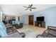 Open living space with tile flooring, modern furniture, and seamless flow to the kitchen area at 2628 Sherman Oak Dr, North Port, FL 34289
