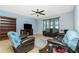 Comfortable living room with leather seating, ceiling fan, and tiled floors at 2628 Sherman Oak Dr, North Port, FL 34289