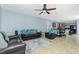 Spacious living room with tile floors, ceiling fan, and open floor plan into the kitchen at 2628 Sherman Oak Dr, North Port, FL 34289