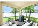 Relaxing screened-in patio with brick flooring, outdoor seating, and a view of the lush backyard at 2628 Sherman Oak Dr, North Port, FL 34289