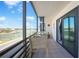 Enjoy waterfront views from this covered balcony featuring seating and a peaceful ambiance at 2727 N Beach Rd # 113, Englewood, FL 34223